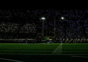 Young football players celebrating during a professional stadium match in 2026