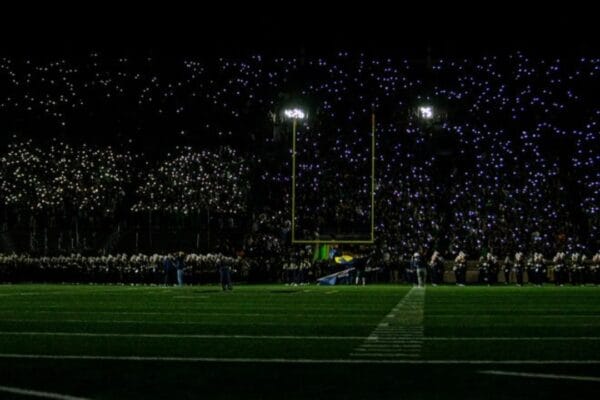 Young football players celebrating during a professional stadium match in 2026