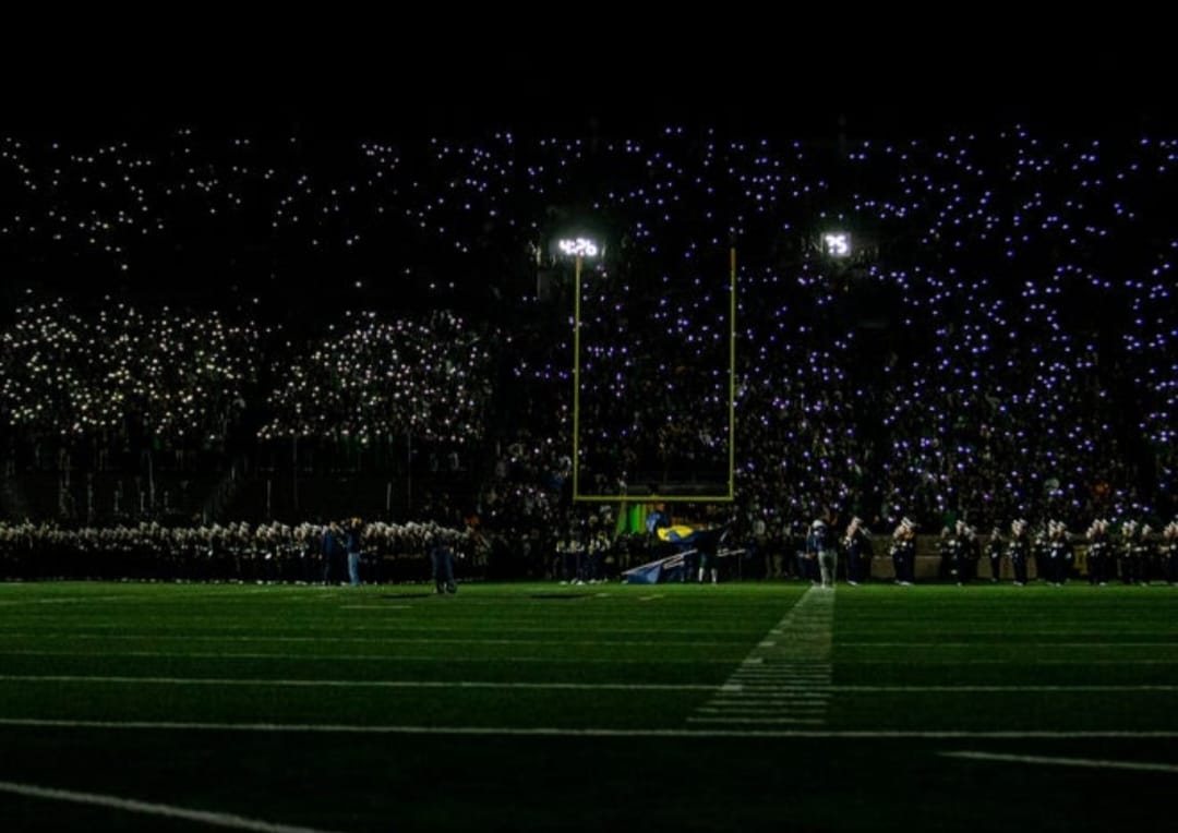 Young football players celebrating during a professional stadium match in 2026